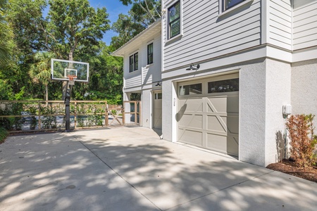 The spacious driveway doubles as an outdoor basketball court