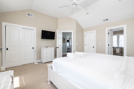 Unwind in your spacious master suite with vaulted ceilings, crisp white linens, and entertainment at your fingertips.
