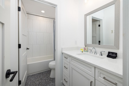 Step into your freshly updated bathroom with a tiled tub-shower combo and large vanity