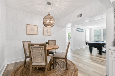 Gather around your elegant dining table beneath the stunning woven pendant light, then challenge friends to pool in the adjoining game room.