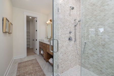 Step into your spa-like ensuite with stunning hexagonal tile work and spacious glass shower—your personal sanctuary awaits.