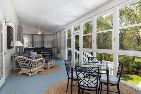Relax in your private sun room where floor-to-ceiling windows frame pool views
