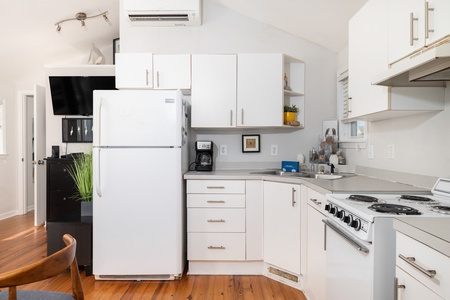 Your bright, well-equipped kitchen offers everything you need to prepare delicious meals, complete with modern appliances and plenty of counter space. Fresh coffee awaits you each morning in this cheerful, sunny space.