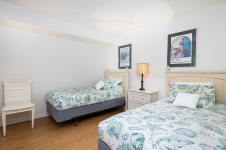 Rest peacefully in your charming twin bedroom, where coastal-themed bedding and cheerful artwork create the perfect retreat for family or friends.