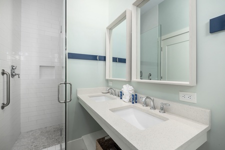 The primary en suite bathroom offers a walk-in shower and dual vanity