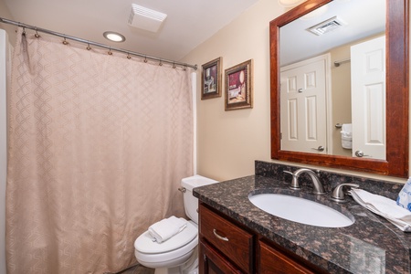 The twin en suite bathroom features a tub-shower combo