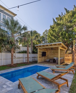 Relax by your private pool surrounded by tropical palms, with a shaded outdoor lounge perfect for afternoon drinks.