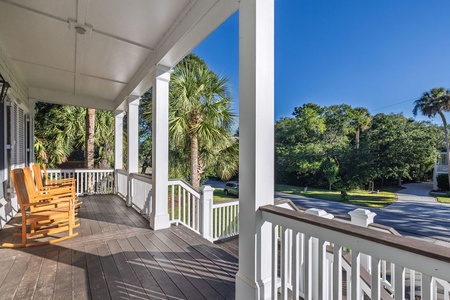 Relax in your wooden rocking chairs on this charming covered porch.