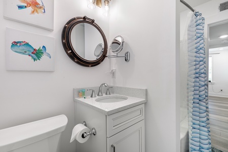 Step into your charming nautical-themed bathroom with porthole mirror