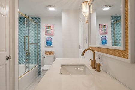 The third bathroom features a tub-shower combo