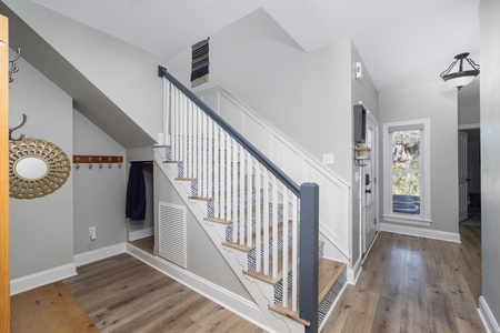 Step into your stylish entryway where warm wood floors and thoughtful details create an inviting first impression of your home away from home.