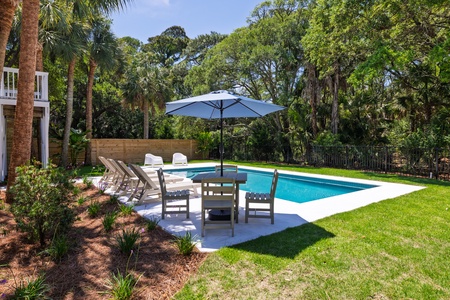 Relax under the umbrella next to your pool