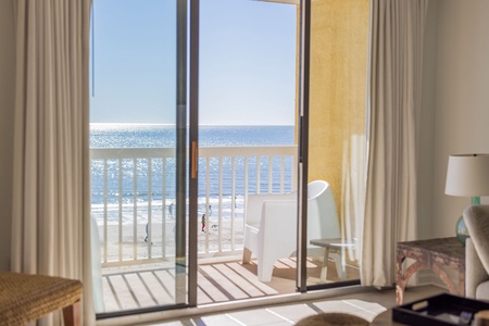 Bright and airy living room that opens directly to the balcony, showcasing breathtaking oceanfront scenery