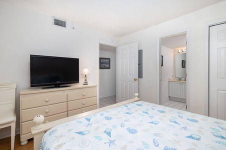 Your peaceful queen bedroom retreat features comfortable bedding, a TV and access to the shared bath.
