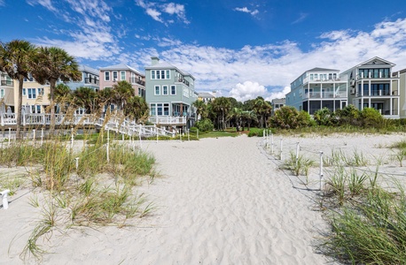 Feel the warm sand beneath your feet as you follow the winding path through the dunes to the sparkling shoreline