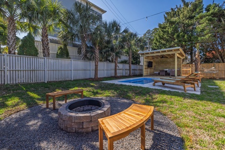 Your private backyard oasis features a sparkling pool, cozy fire pit, and shaded pavilion—perfect for morning swims and evening gatherings under the palms.