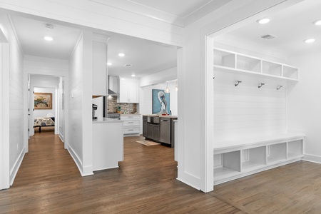 The entryway welcomes you with a built-in storage bench and coat hooks