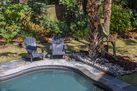 Unwind in your private pool oasis with comfortable seating and tropical landscaping creating the perfect backyard retreat.