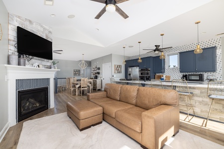 Sink into plush leather seating while the fireplace warms your evening and modern kitchen beckons for home-cooked meals.