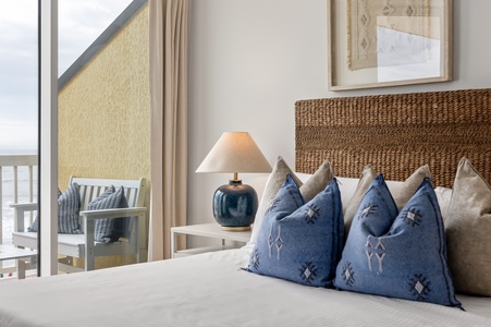 Sink into plush linens and beautifully patterned pillows in your serene bedroom retreat, where natural textures and soft lighting create perfect relaxation.