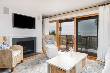 Unwind in your comfortable living room with cozy fireplace, large TV, and seamless access to your private deck overlooking the ocean.