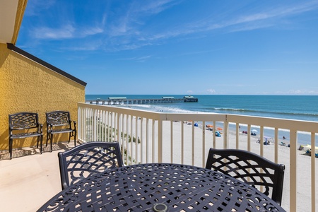 Take the glass sliding doors from the living room to your private balcony overlooking the water