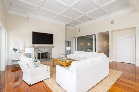 A beautifully detailed coffered ceiling presides over this light-filled living room