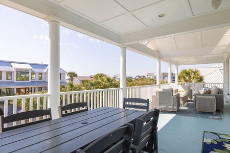 Step out onto your covered balcony with dining table, rocking chairs, and outdoor love seat
