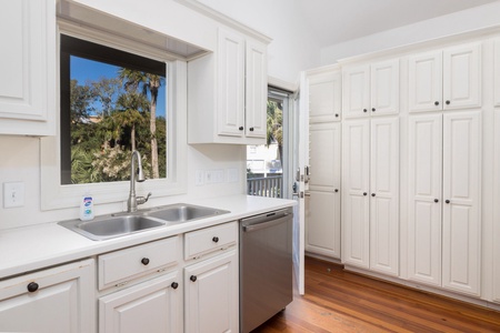 Your kitchen sink window looks out onto a lush tropical landscape