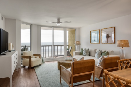 Relax in your bright, coastal-inspired living room with ocean views from your private balcony and comfortable seating for memorable evenings together.