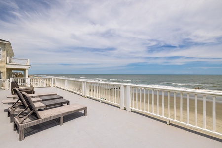 Take the stairs from the covered back deck to your rooftop deck and enjoy panoramic views of the ocean