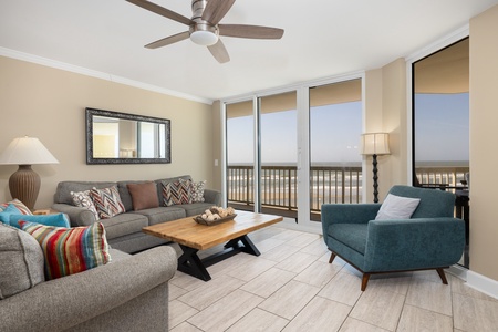 Your bright living room overlooks Folly Beach and the on-site pool