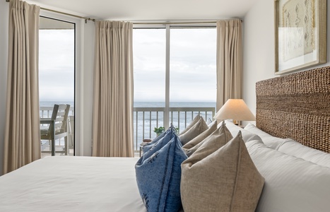Wake up to ocean waves right outside your window in this serene bedroom retreat with stunning sea views.