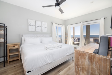 Wake up to stunning ocean views from your cozy bedroom, where crisp linens and gentle sea breezes create the perfect coastal retreat.