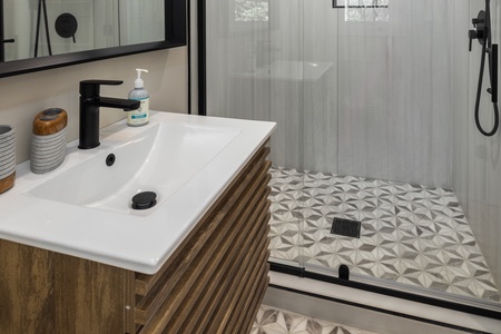 The king en suite features a glass walk-in shower