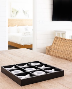 Your elegant teacup set awaits on the wooden table, ready for peaceful afternoon moments with a view of crisp white linens.