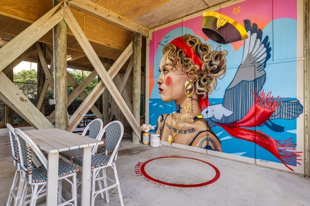 A stunning mural from local artist Riivo Krruk features a female pirate who was said to have grown up in Charleston
