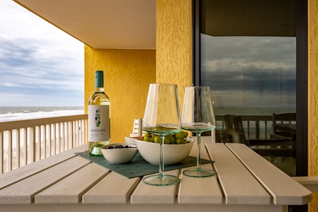 Unwind with wine and snacks on your private balcony while enjoying breathtaking ocean views.