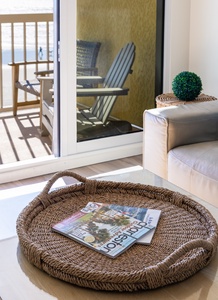 Curl up with your morning coffee on plush sofas while sunlight streams through doors to your private balcony.