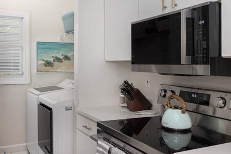 Just off your kitchen is a laundry room featuring a full-sized washer and dryer