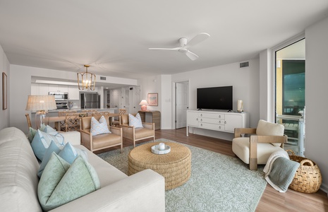 Sink into soft seating with calming coastal colors, where your open living space flows seamlessly into a fully equipped kitchen for effortless entertaining.