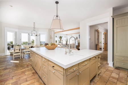 A large center island overlooks the living space and dining room