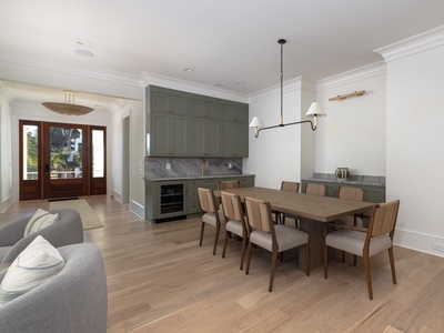 Gather around your spacious dining table for memorable meals in this elegant open-concept space with designer lighting and built-in bar.