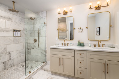 Dual vanities are ready for your morning routine in the primary bathroom