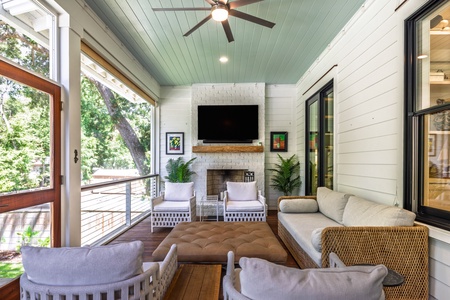Your screened-in deck features an outdoor television and fireplace for entertainment