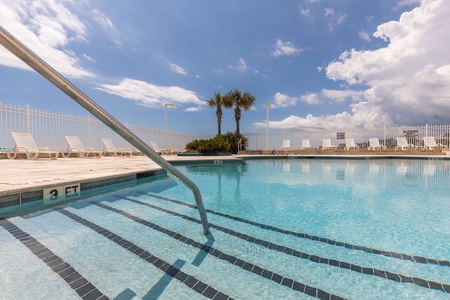 Enjoy a sparkling resort-style pool with palm trees, lounge seating, and sweeping Atlantic views, just steps from your oceanfront condo