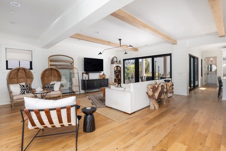 Your main floor living space and sitting room feature exposed wooden beams and cozy furniture