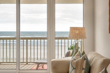 Sink into your coastal retreat as ocean waves become your soundtrack through expansive windows.
