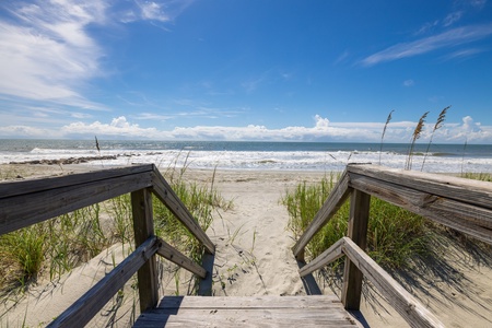 Step onto your private boardwalk and feel the soft sand between your toes. The ocean waves call out just steps from your door, promising sun-soaked mornings and peaceful seaside moments.