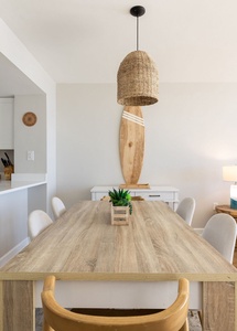 Gather around your stylish dining table where coastal vibes meet modern comfort, perfect for sharing meals and making memories.